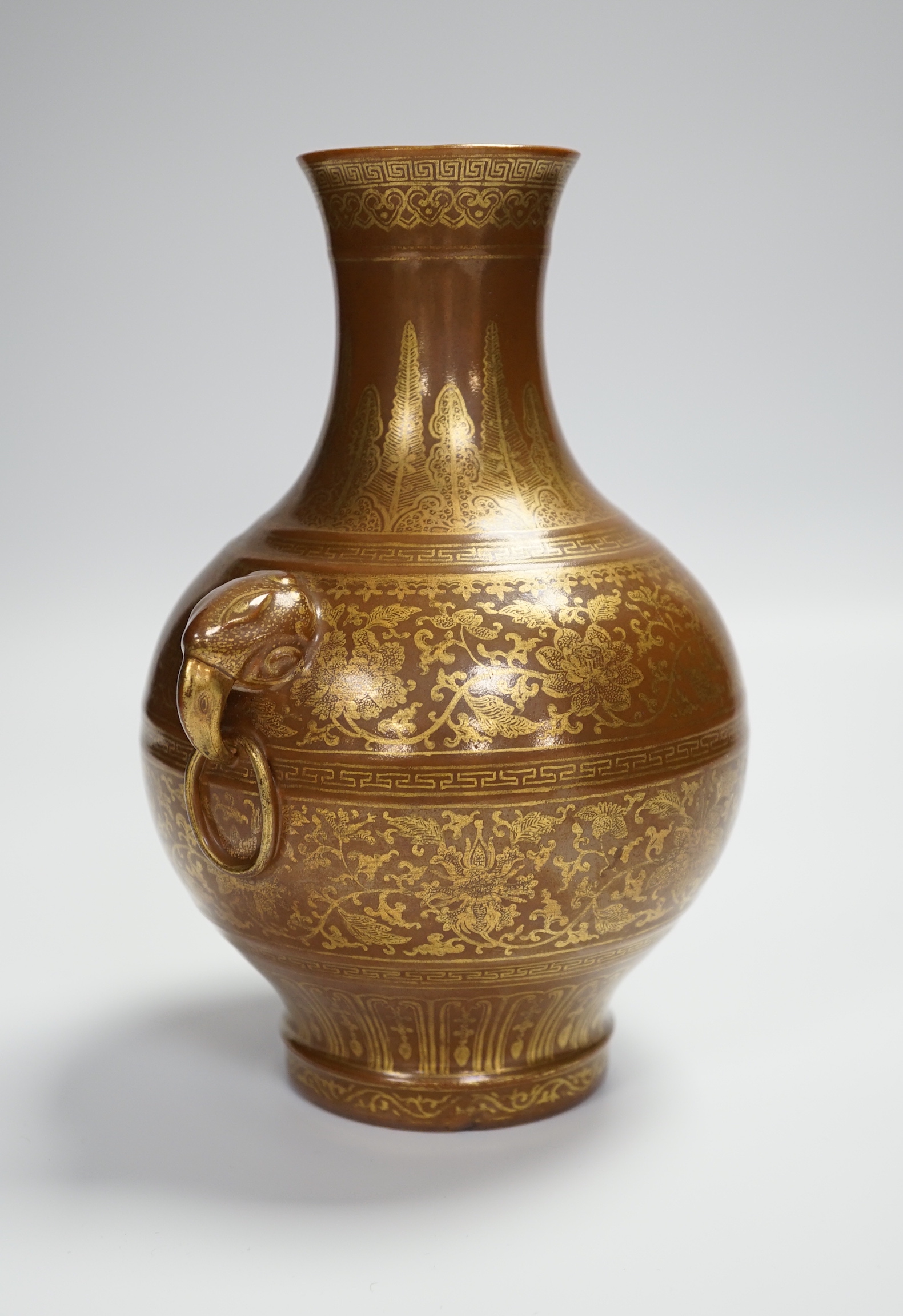 A Chinese porcelain imitation bronze vase, on a brown ground with gilt decoration, 19.5cm high